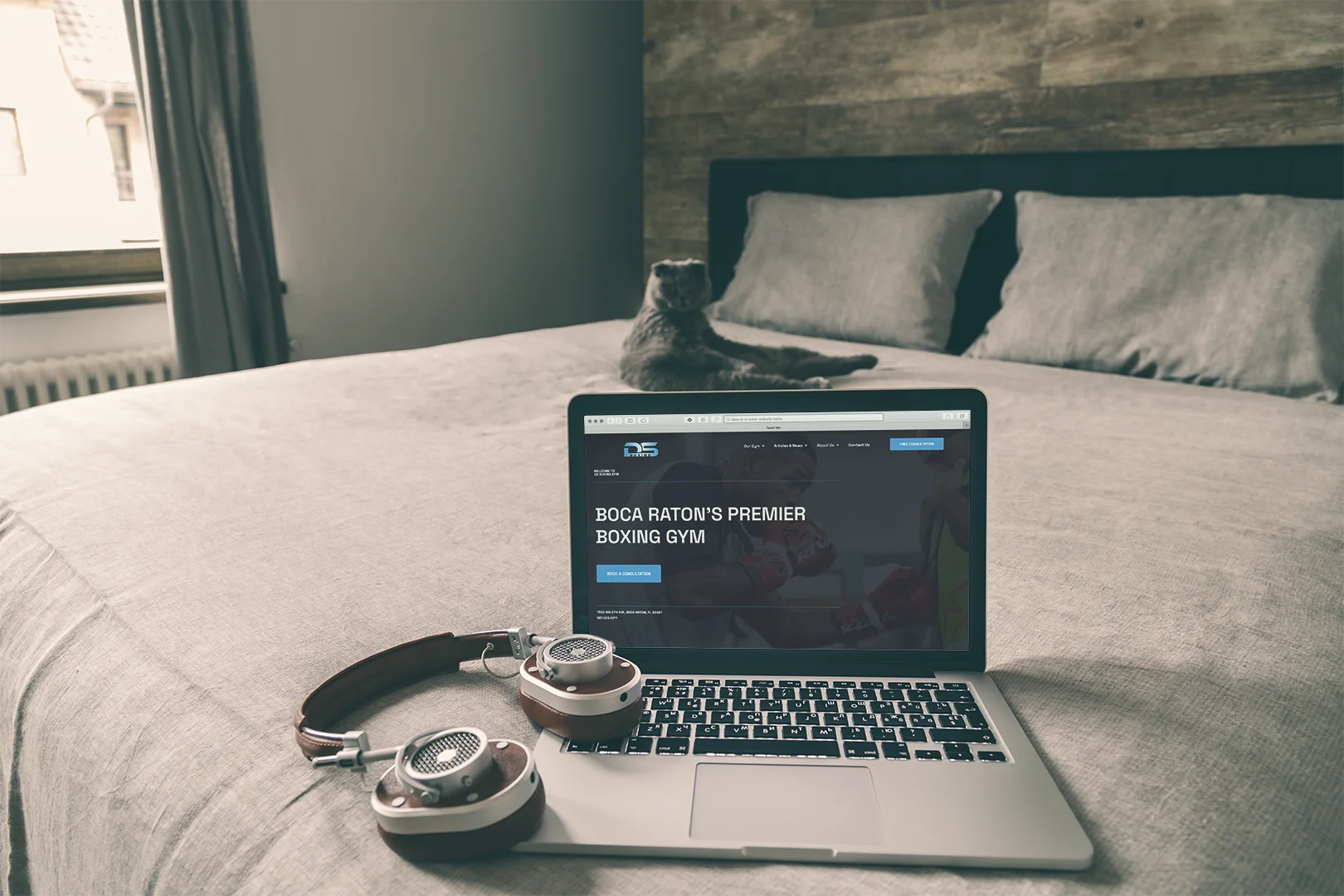 DS Boxing website on laptop on bed